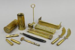 A collection of WWI trench art, including paper knives, miniature fenders,