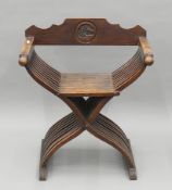 A 19th century walnut x-frame folding armchair. 70.5 cm wide.