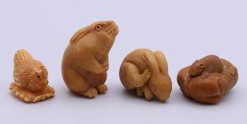 Four tagua nut animal carvings (two hares, a chicken and rats). Tallest 4 cm high.