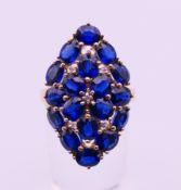 A 9 ct gold blue stone ring. Ring size N/O. 5.5 grammes total weight.