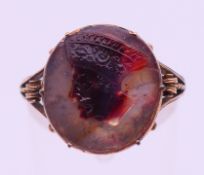 An unmarked gold carved stone intaglio ring. Ring size G. 2.9 grammes total weight.