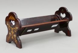 A Victorian inlaid rosewood sliding bookrack. 34.