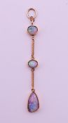 A three-stone opal pendant. 6 cm high, largest opal 1.5 cm high.