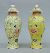 A pair of Chinese porcelain yellow ground vases. Each 29 cm high.