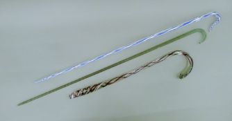 Three Victorian glass walking sticks. The blue and white example 99 cm long.