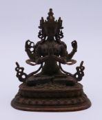 A bronze figure of a Buddhist deity. 10 cm high.