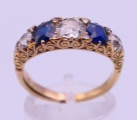 An unmarked gold, sapphire and diamond ring. Ring size P/Q. 4.3 grammes total weight.