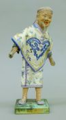 A 19th century model of a Chinese gentleman wearing an embroidered silk robe. 27 cm high.