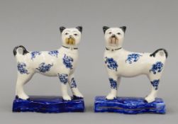 A pair of Staffordshire pottery pug dogs, circa 1850. Each 16 cm high.