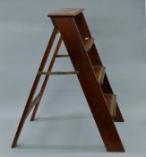 A set of mahogany and brass library steps. 89 cm high.
