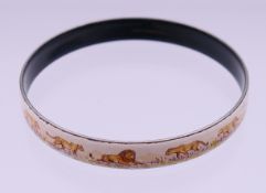 A Hermes Paris enamel narrow bangle decorated with lions, stamped Hermes Paris and Made in Austria.