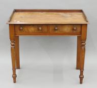 A Victorian mahogany two-drawer side table. 91 cm wide.