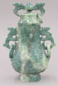 A Chinese spinach green stone vase and cover. 18 high.