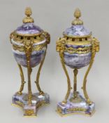 A pair of large gilt metal-mounted fluorite lidded urns. Each 49 cm high.