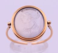An unmarked gold intaglio quartz swivel bezel ring. Ring size P. 3.7 grammes total weight.
