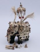 A Sri Lankan Kandy elephant of carved wood with silver decorative overlay, boxed. 15 cm high.