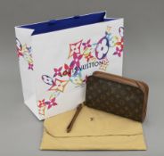 A Louis Vuitton Orsay bag, in dust bag. The former 23.5 cm wide.