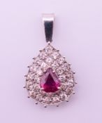 An unmarked ruby and diamond pendant. 3 cm high including suspension loop. 3.5 grammes total weight.
