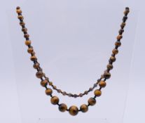 A graduated tiger's eye bead necklace.