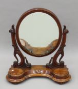 A Victorian mahogany toilet mirror. 82 cm high.