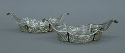 A pair of pierced silver bonbon dishes. Each 18.5 cm long. 158.7 grammes.
