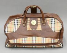A vintage Burberrys Sport holdall with lower zippered compartment. 57 cm long.