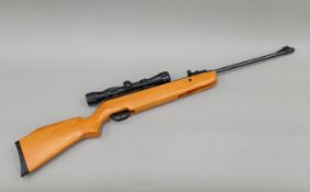 A Crosman Quest air rifle with scope. 105 cm long.