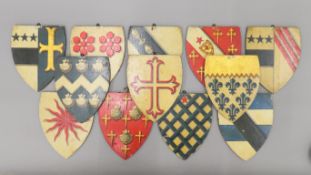 Twelve vintage painted wooden walling-hanging shields. Each 20 cm high.