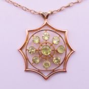 A 9 ct gold peridot pendant on chain. Pendant 3.