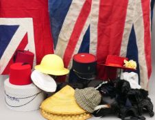 A quantity of various vintage clothes, hats, bonnets and flags. The largest flag 225 x 105 cm.
