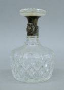 A cut glass decanter mounted with a silver locking mechanism by Hukin & Heath. 20 cm high.
