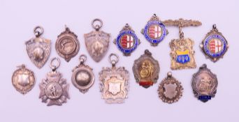 Fourteen silver fobs, mostly sporting related including, three West Essex Churches Football league,