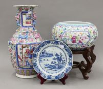A 19th century Canton porcelain vase, an 18th century Chinese plate and a Chinese vase on a stand.