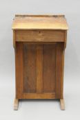 A vintage oak school desk with brass fittings for The Bennet Furnishing Co Ltd, Glasgow and London.