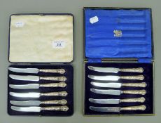 Two cased sets of silver-handled King's pattern tea knives. The larger case 21 cm wide.