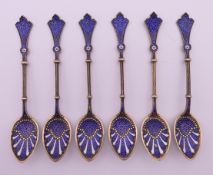 A set of six silver and enamel teaspoons. 11 cm long.