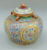 A 19th century Chinese famille rose porcelain storage jar and cover. 27 cm high.