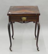 An Edwardian mahogany envelope card table. 56 cm square.