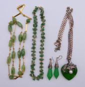 A silver chain with silver mounted green stone heart pendant,