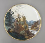 A Mettlach pottery charger depicting a Rhenish castle view. 43 cm diameter.