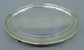 A George III silver teapot stand with engraved armorial to centre.