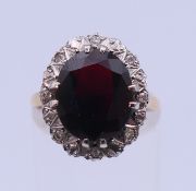 A 9 ct gold and garnet dress ring. Setting 1.7 cm high, ring size M/N. 4.1 grammes total weight.