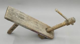 A 19th century wooden screw vice for a work bench. 79 cm long.