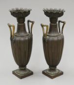 A pair of 19th century bronze and bronzed twin-handled vases. Each 28.5 cm high.