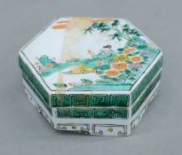 A Chinese famille verte porcelain hexagonal lidded box. 9 cm wide.
