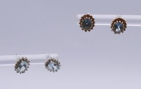 A pair of 9 ct white gold and aquamarine ear studs and a pair of 18 ct gold and aquamarine ear