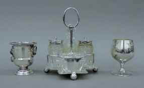 A silver-plated cruet stand, a silver-plated goblet and a small silver-plated urn. The former 16.