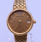A Bueche-Girod 9 ct gold ladies wristwatch with date aperture and textured link bracelet. Case 2.