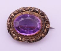 A 19th century amethyst oval brooch. 2.5 x 2 cm.
