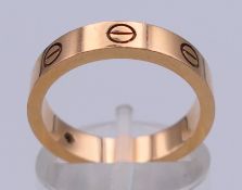 An 18 ct gold and diamond set Cartier Love ring, marked Cartier CC 6886, 750 and 54.